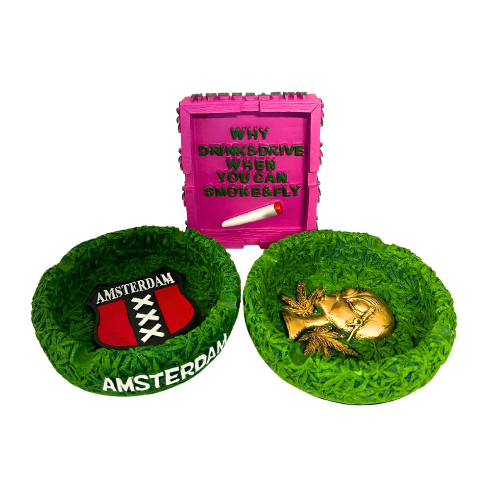 Pink container with text and a cigarette, two green bowls with 'Amsterdam' branding, and a gold heart-shaped object on a white background.