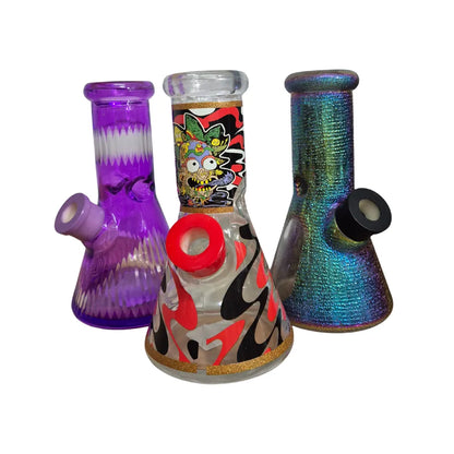 Three colorful glass smoking bongs on a white background