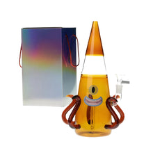 Novelty glass with an octopus-face design next to a colourful gift box on a white background