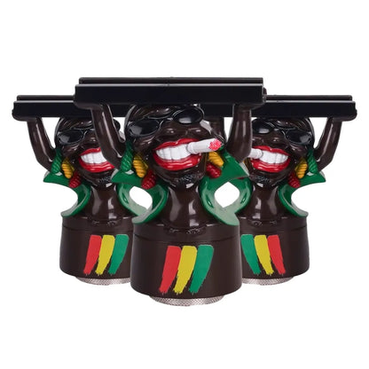Three black "jamaica with a slim" grinders with colourful designs on a white background