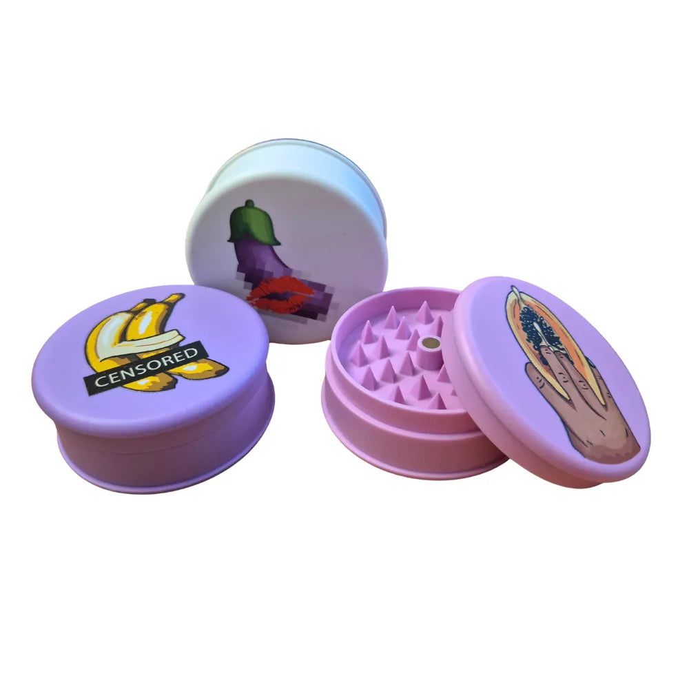 Three colourful Magic Leaf "Print-Collection" plastic grinders with censored inspired designs.