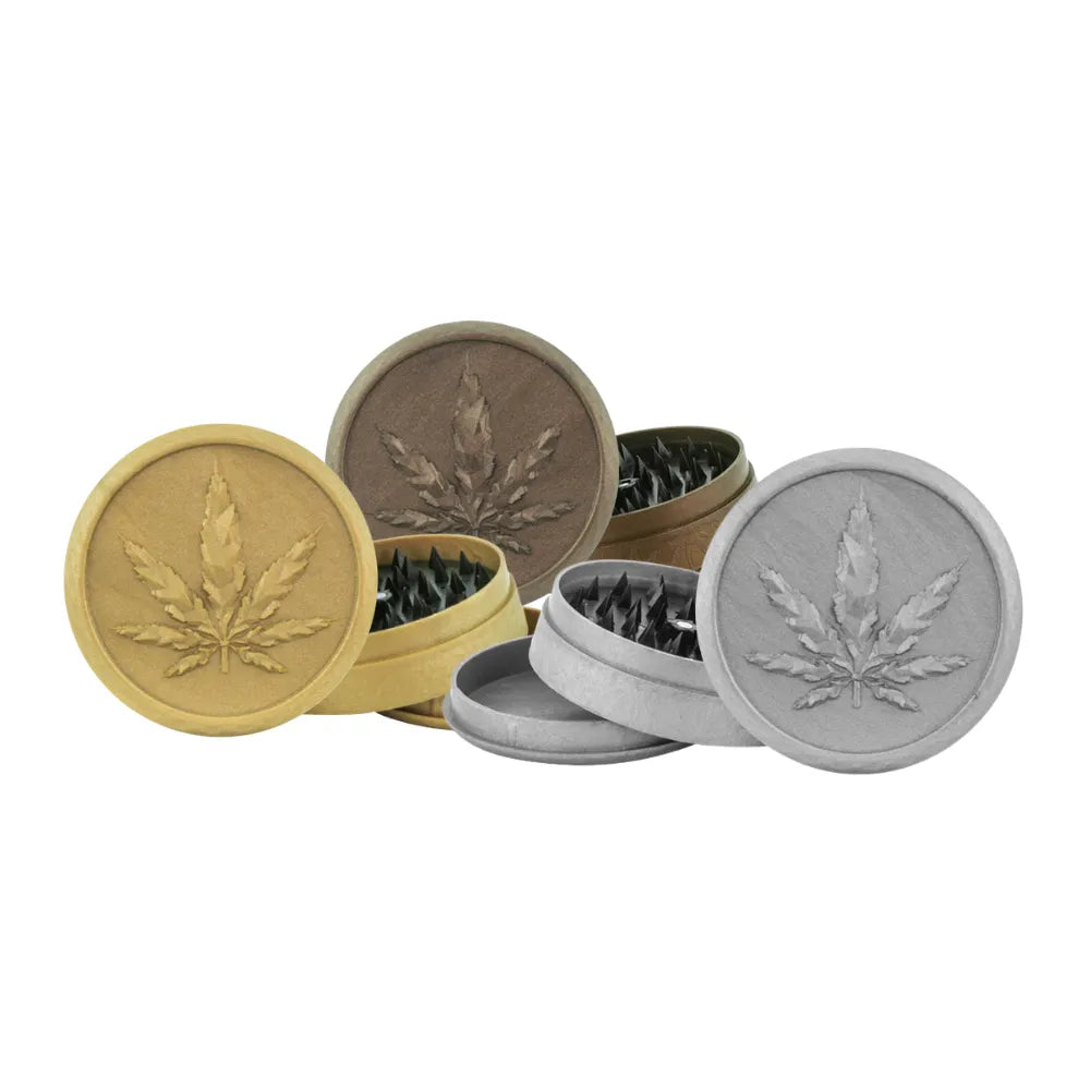 Three gold and silver Magic Leaf plastic soft touch grinders on a white background
