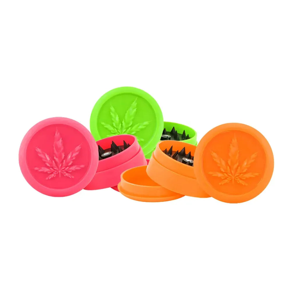 Three colourful Magic Leaf plastic soft touch grinders on a white background