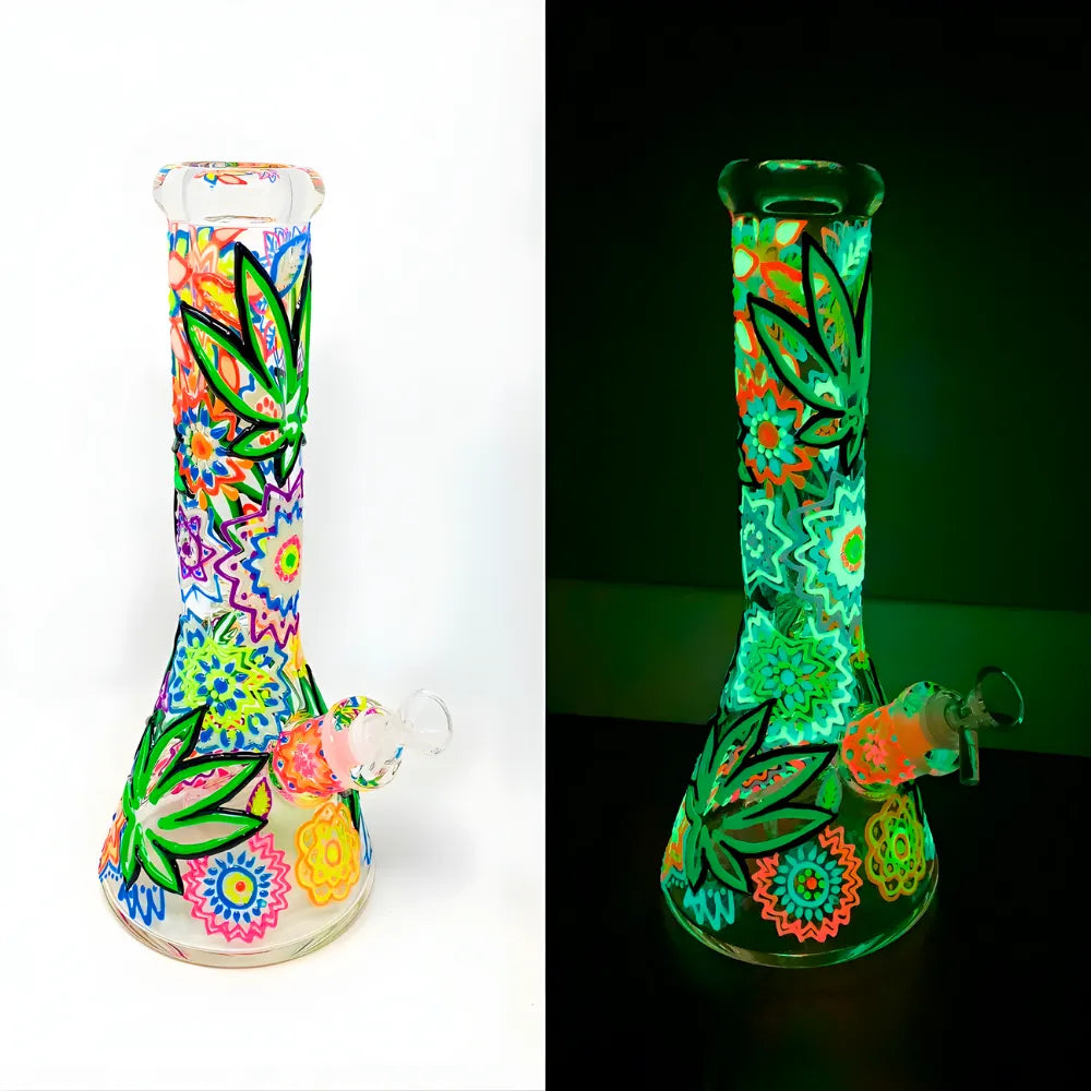 Glass smoking device with colourful designs under normal light and glowing under black light.