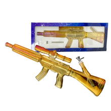 A gold-metallic automatic rifle inspired waterpipe with packaging on a white background