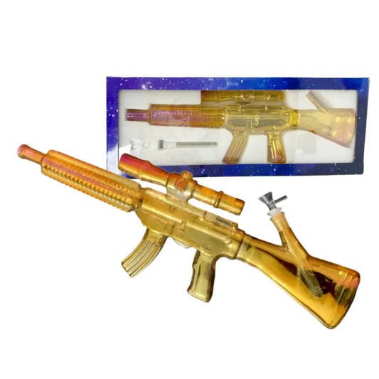 A gold-metallic automatic rifle inspired waterpipe with packaging on a white background