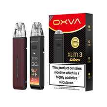 Two OXVA Xlim 3 Ultra in the colour "Bordeaux Red" with a LED screen beside black and red packaging on a white background.