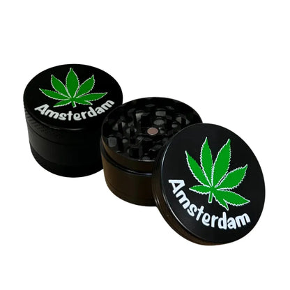 Two black, open pocket size tobacco grinders with "Amsterdam" print on a white background