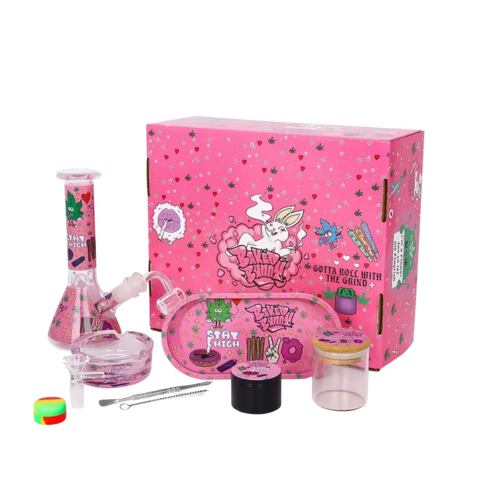 Pink cannabis smoking accessory set with a box featuring cartoon designs on a white background.