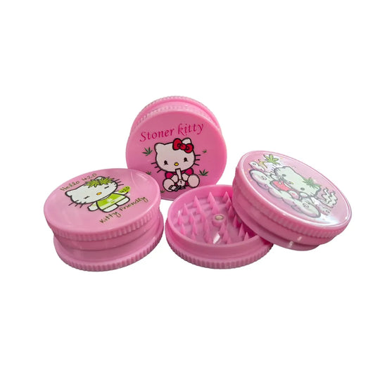 Three "Stoner Kitty" pink 3-part plastic grinders on a white background